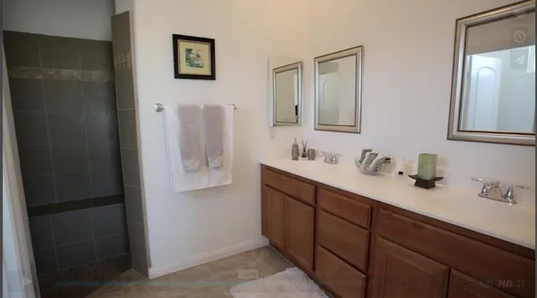 a bathroom with a double vanity sink and mirror