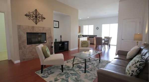 a dining room with furniture a rug and wooden floor