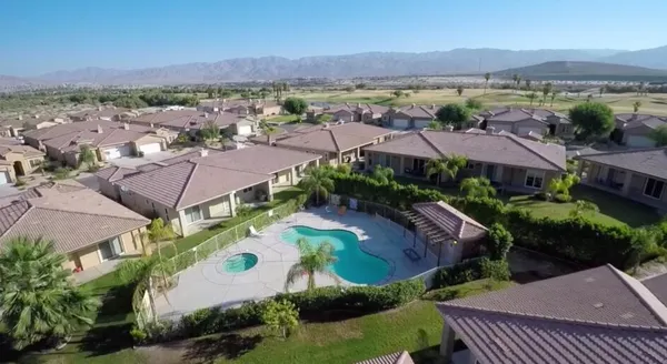 an aerial view of residential houses and outdoor space
