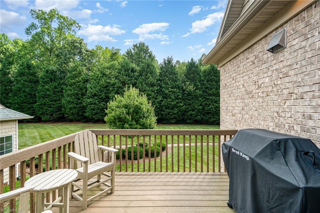 7907 Quiet Place Oak Ridge, NC 27310 - Photo 36 of 49 Deck on the main level sunroom with a gas line for the grill