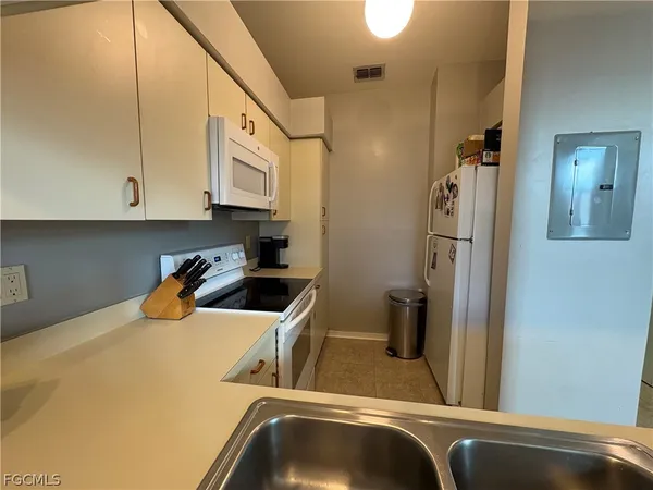 a kitchen with a refrigerator and sink