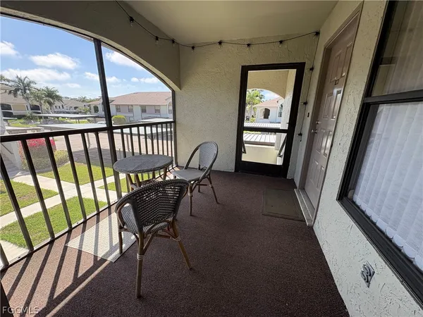 a view of a porch with furniture and wooden floor
