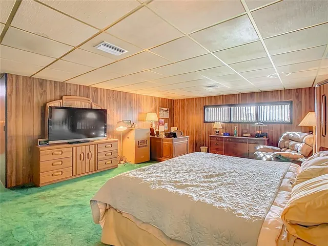 a bedroom with a bed and a couch