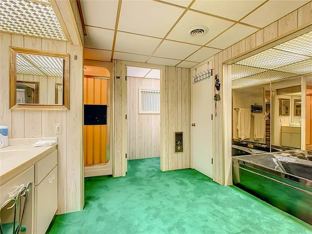 a living room with furniture and a kitchen view