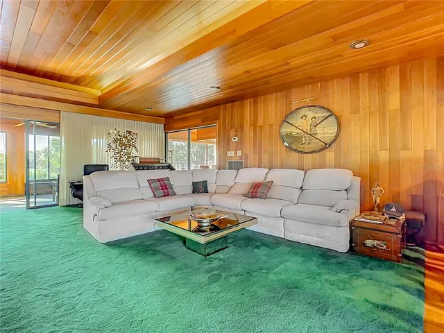 a bed room with a bed and a view of kitchen