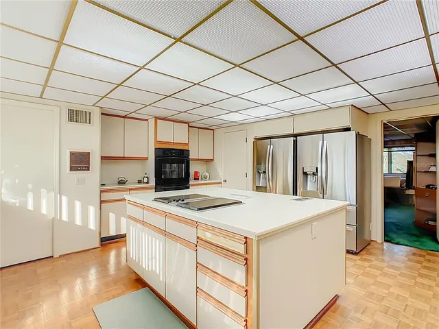 a kitchen that has a sink a stove and a refrigerator