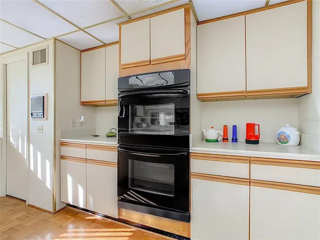 a kitchen with stainless steel appliances granite countertop a refrigerator and cabinets