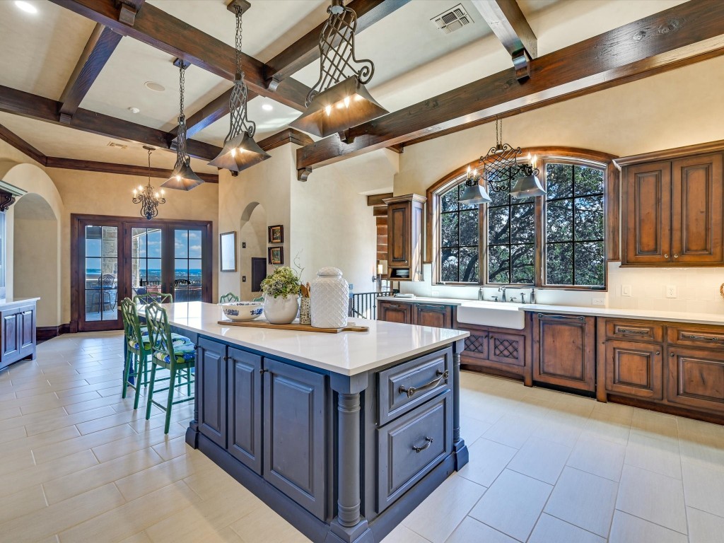 2515 Boot Ranch Circle Fredericksburg, TX 78624 - Photo 23 of 36 a kitchen with stainless steel appliances granite countertop a sink and wooden cabinets