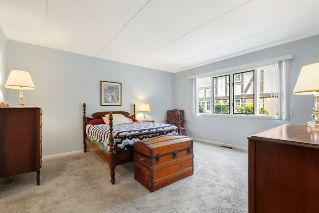 a bedroom with furniture and a window