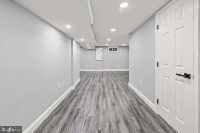 a view of hallway with wooden floor