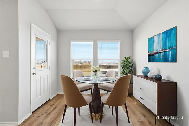 a dining room with furniture and window
