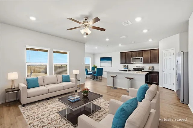 a living room with furniture and kitchen view