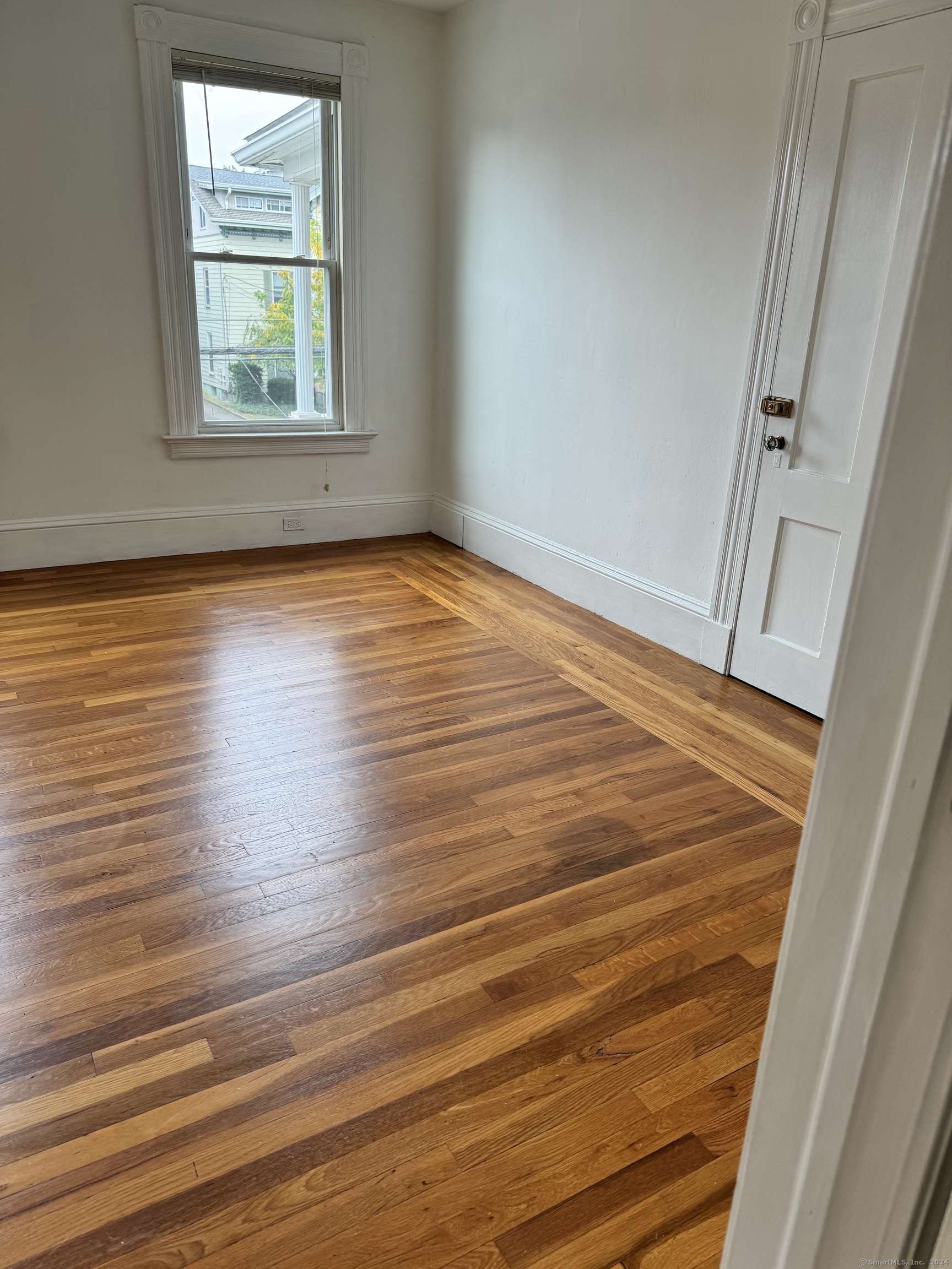 751 Orange Street New Haven, CT 06511 - Photo 11 of 18 an empty room with wooden floor and windows