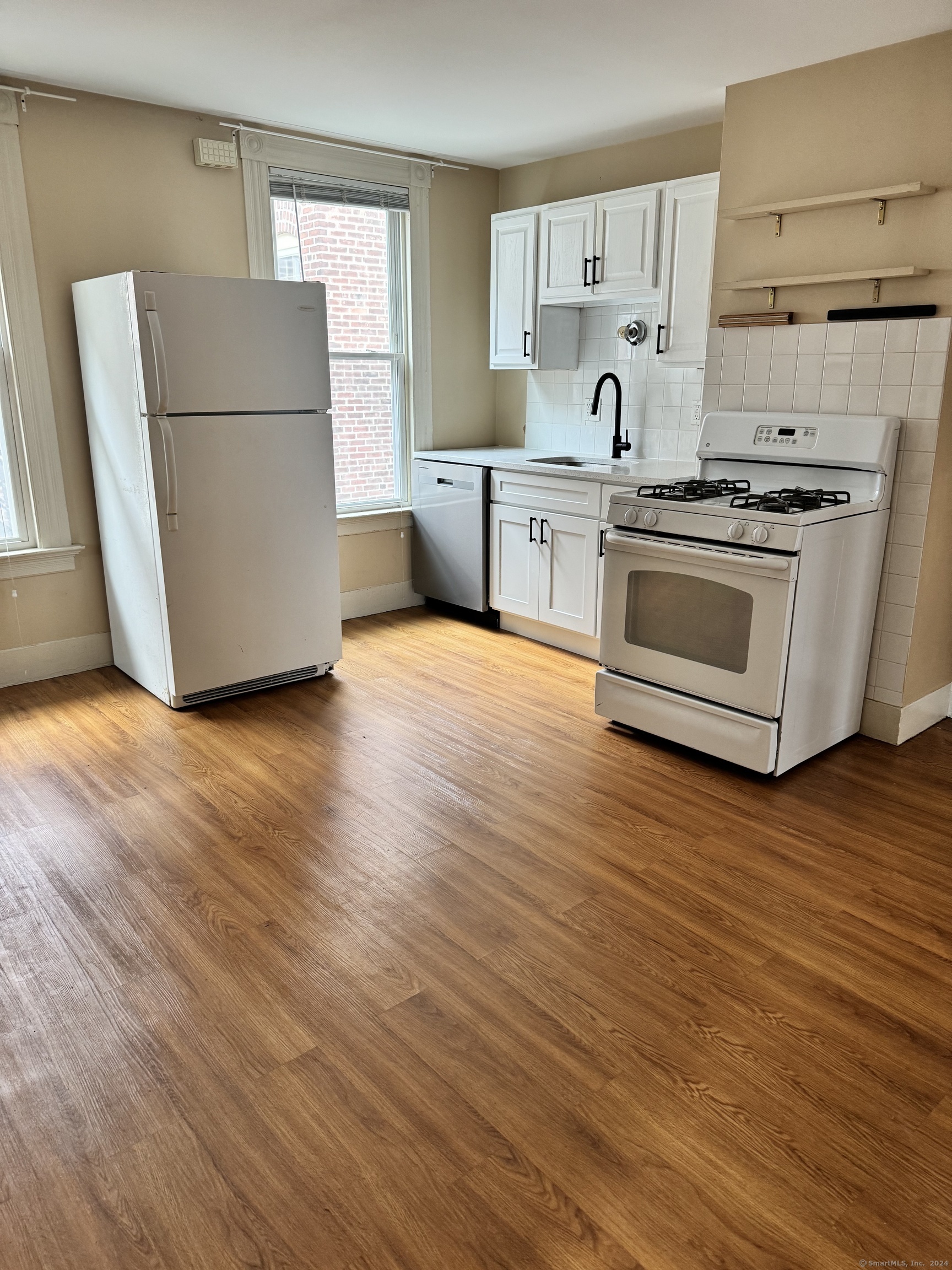 751 Orange Street New Haven, CT 06511 - Photo 7 of 18 a kitchen with wooden floors and white appliances