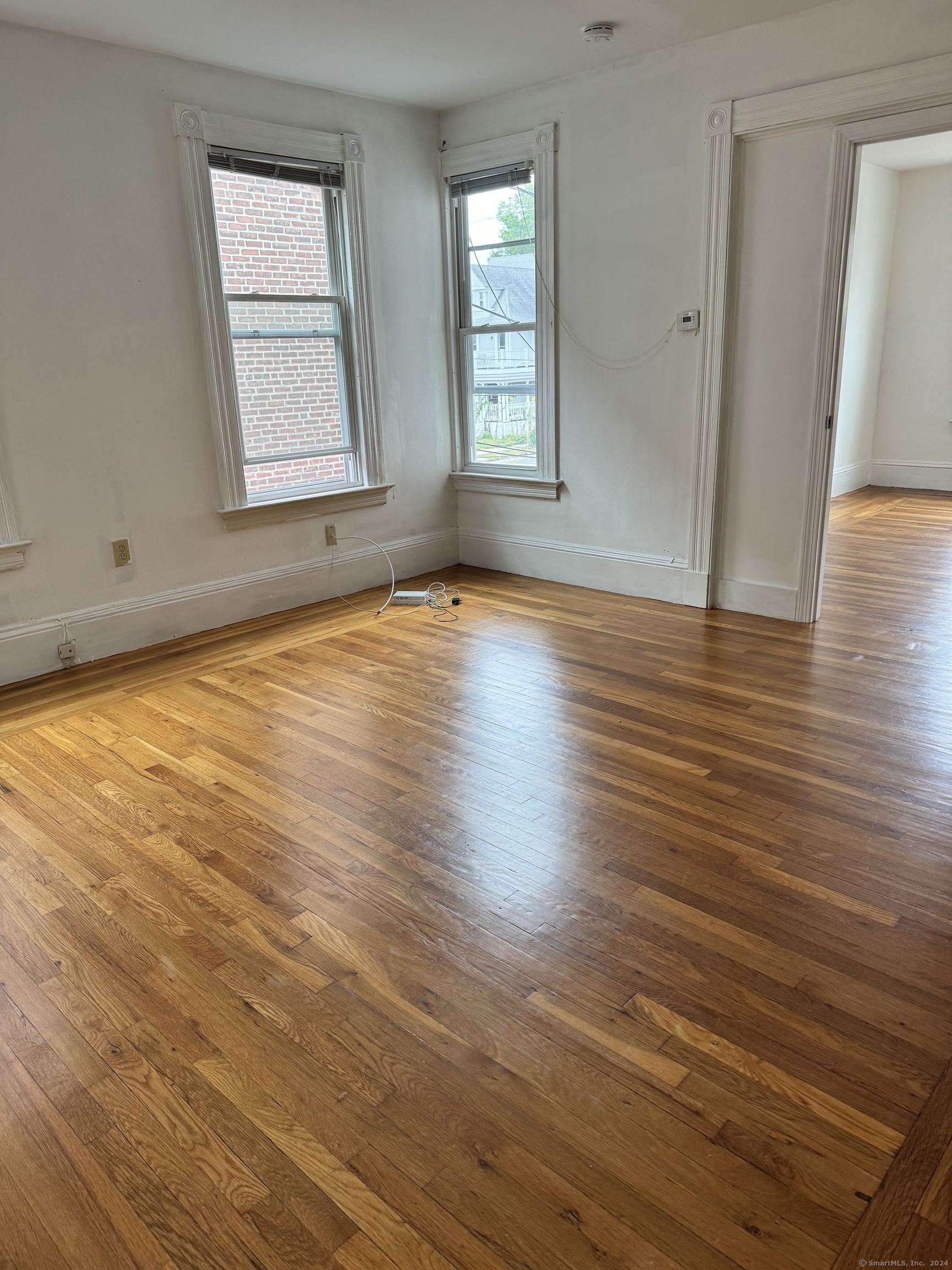 751 Orange Street New Haven, CT 06511 - Photo 10 of 18 an empty room with wooden floor and windows