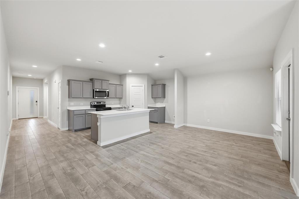 701 Griffith Pk Trail Alvarado, TX 76009 - Photo 3 of 20 a large white kitchen with a refrigerator a sink and a stove top oven