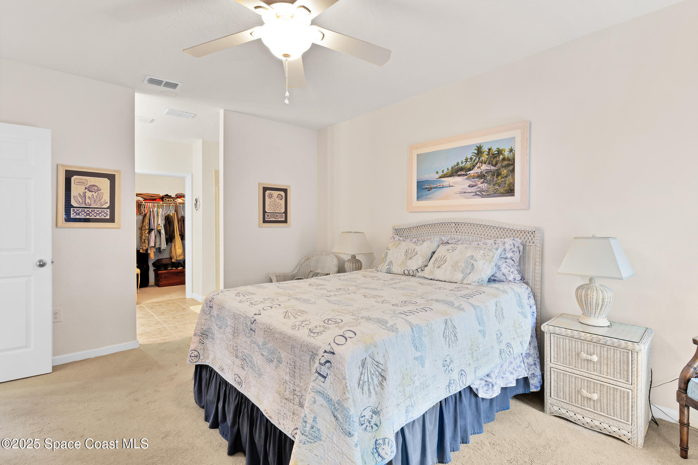 237 Briarcliff Circle Sebastian, FL 32958 - Photo 15 of 43 a bedroom with a bed and a chandelier