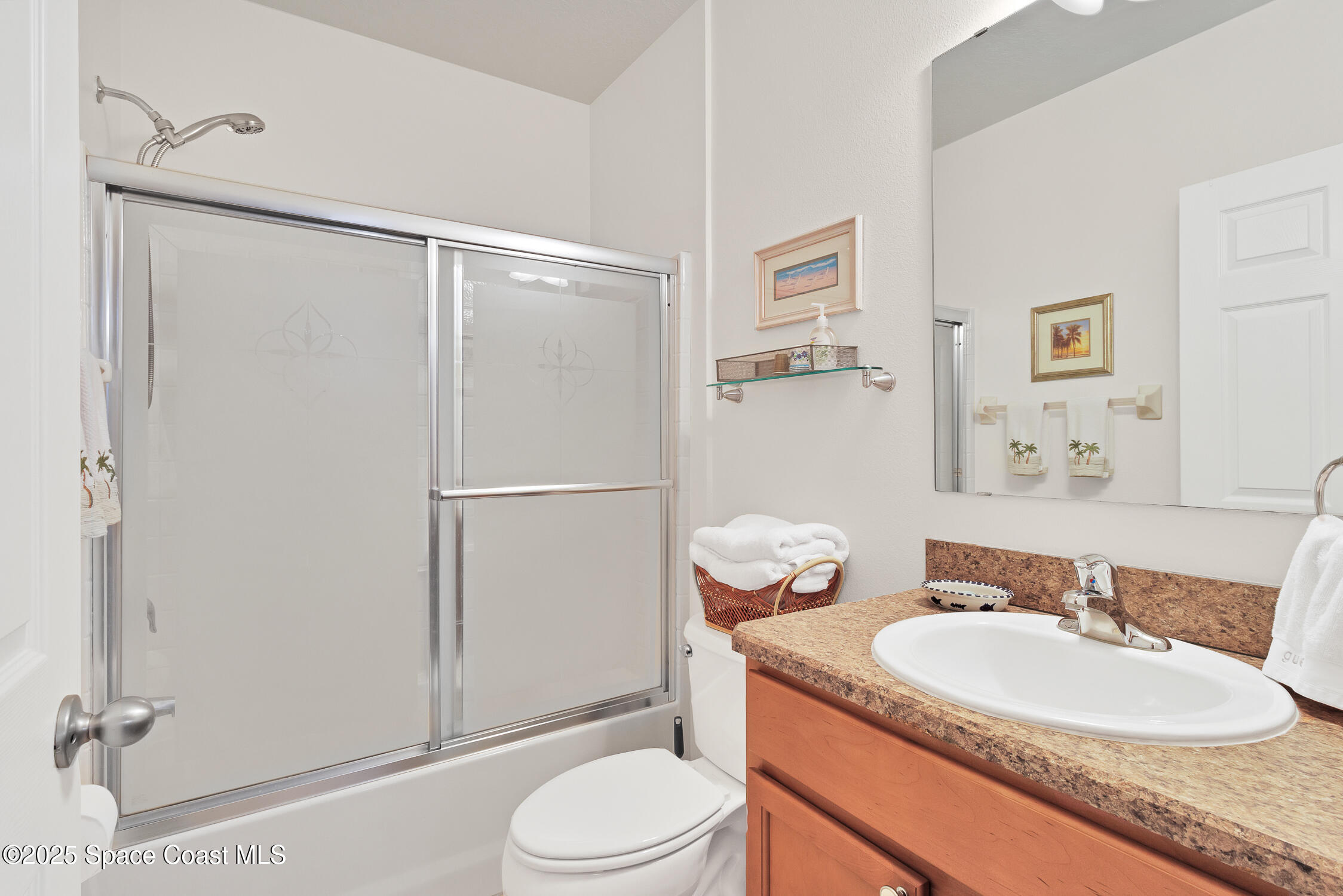 237 Briarcliff Circle Sebastian, FL 32958 - Photo 20 of 43 a bathroom with a granite countertop sink toilet a mirror a vanity and shower