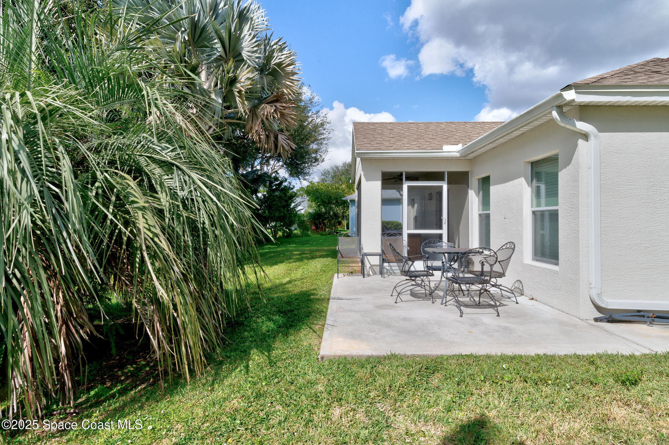 237 Briarcliff Circle Sebastian, FL 32958 - Photo 29 of 43 a view of a patio with table and chairs potted plants and floor to ceiling window