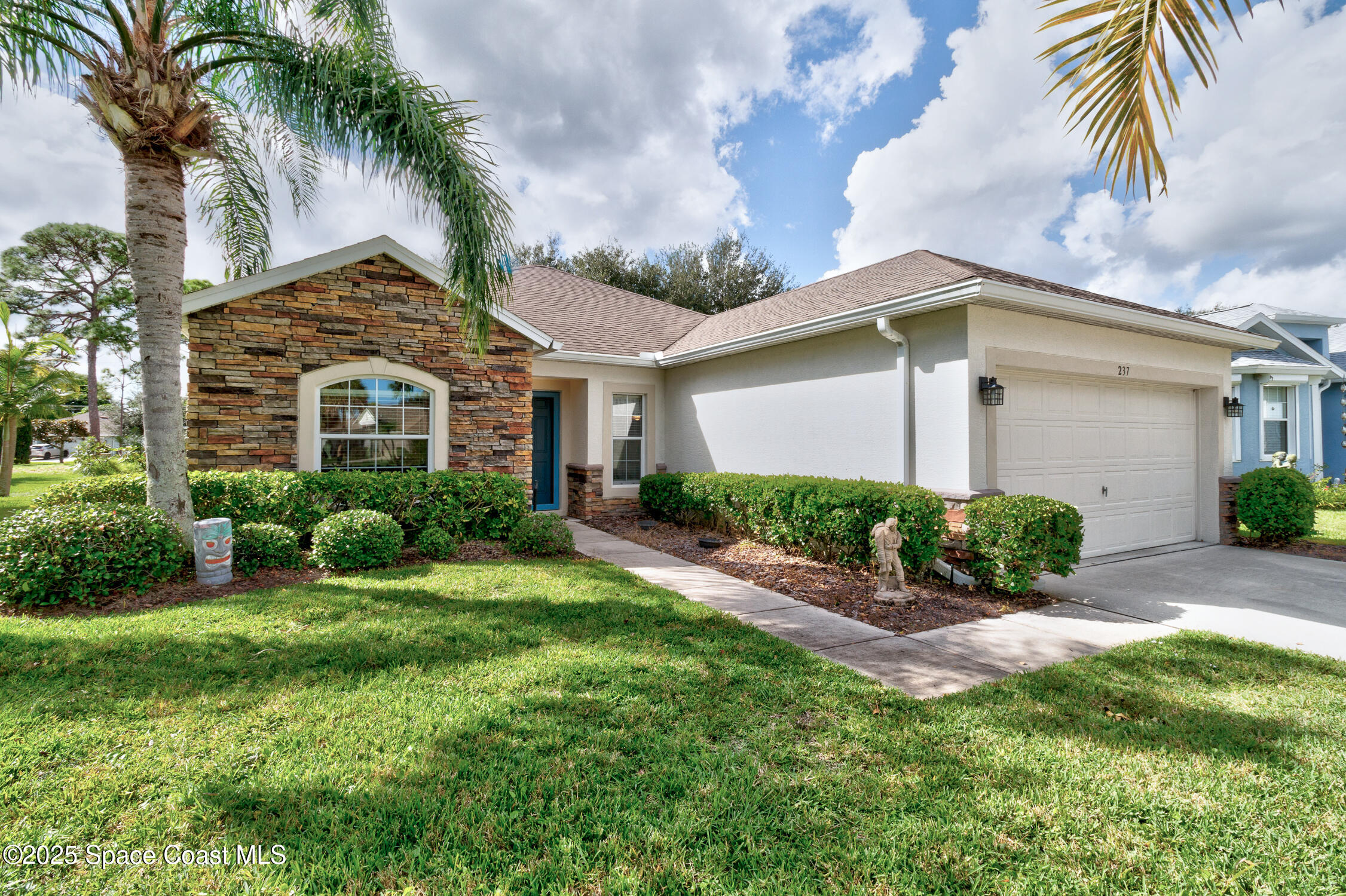 237 Briarcliff Circle Sebastian, FL 32958 - Photo 3 of 43 a front view of a house with a garden