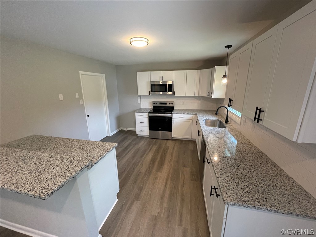 2731 Kinvan Road Henrico, VA 23231 - Photo 13 of 27 a kitchen with stainless steel appliances granite countertop a stove and a sink