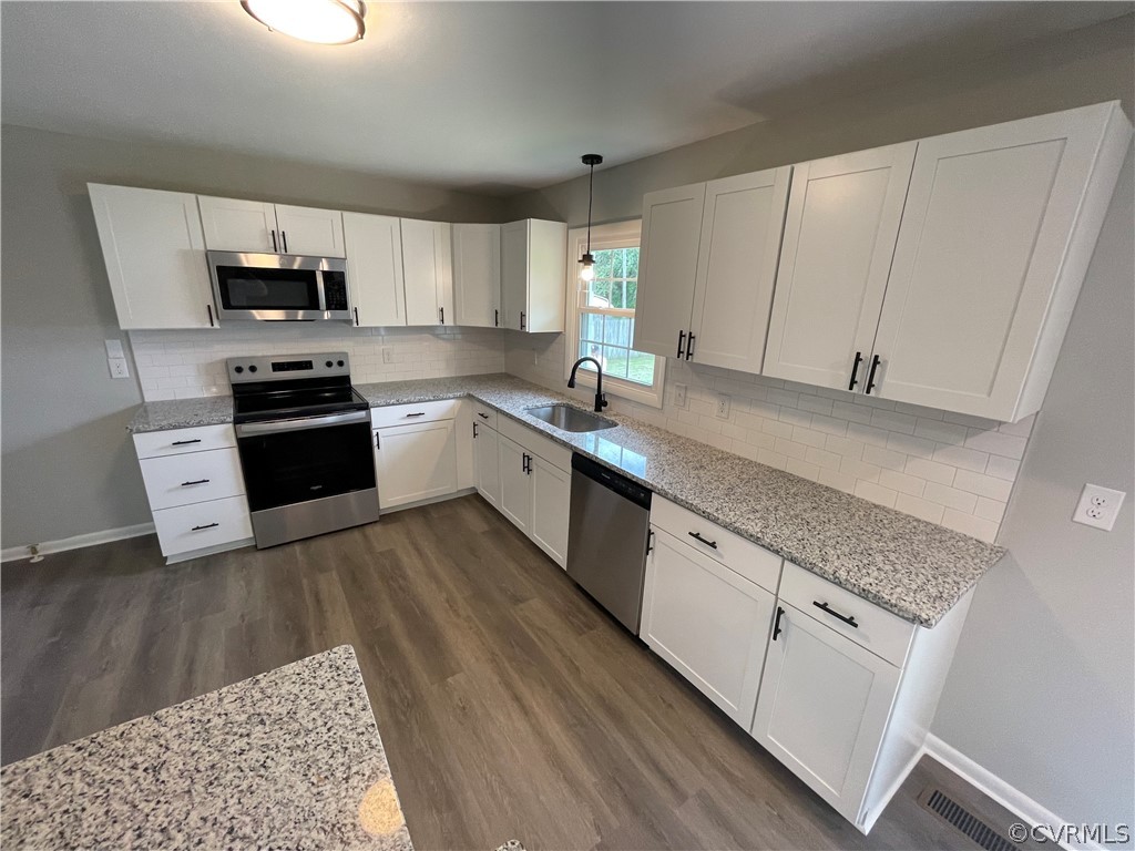 2731 Kinvan Road Henrico, VA 23231 - Photo 14 of 27 a kitchen with granite countertop white cabinets and white appliances