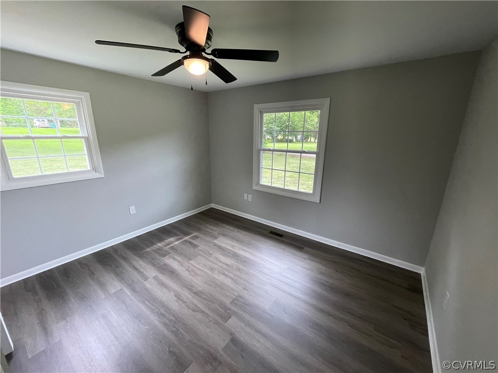 2731 Kinvan Road Henrico, VA 23231 - Photo 16 of 27 a view of an empty room with wooden floor and a window