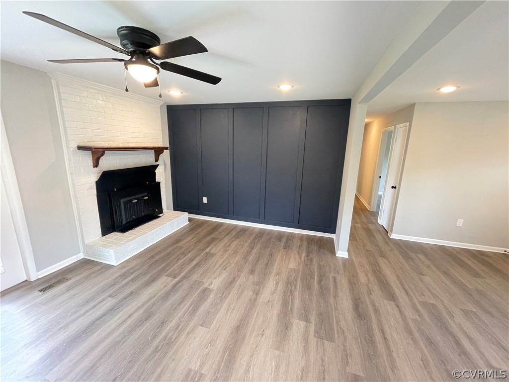 2731 Kinvan Road Henrico, VA 23231 - Photo 7 of 27 a view of an empty room with wooden floor and a fireplace