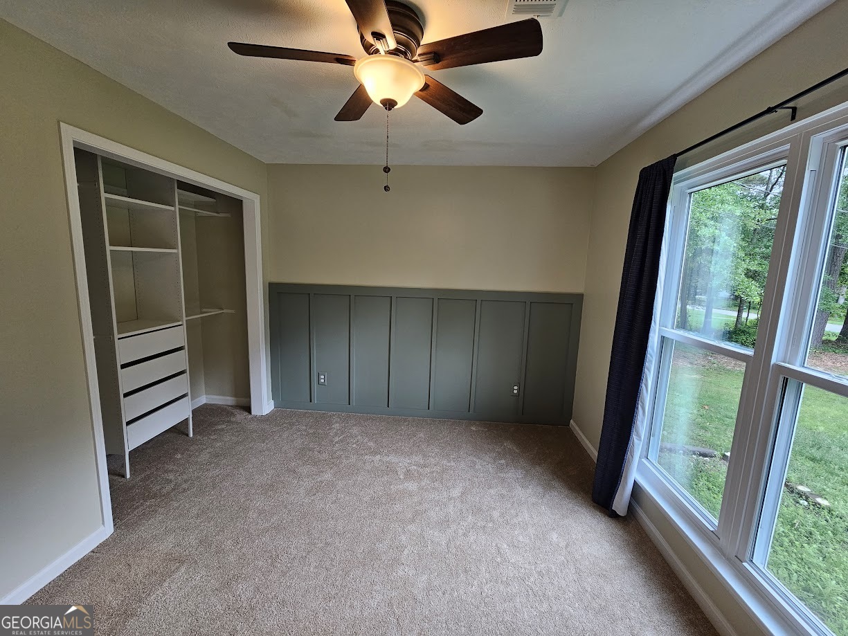 65 Tralee Trace Sharpsburg, GA 30277 - Photo 11 of 21 wooden floor in an empty room with a window