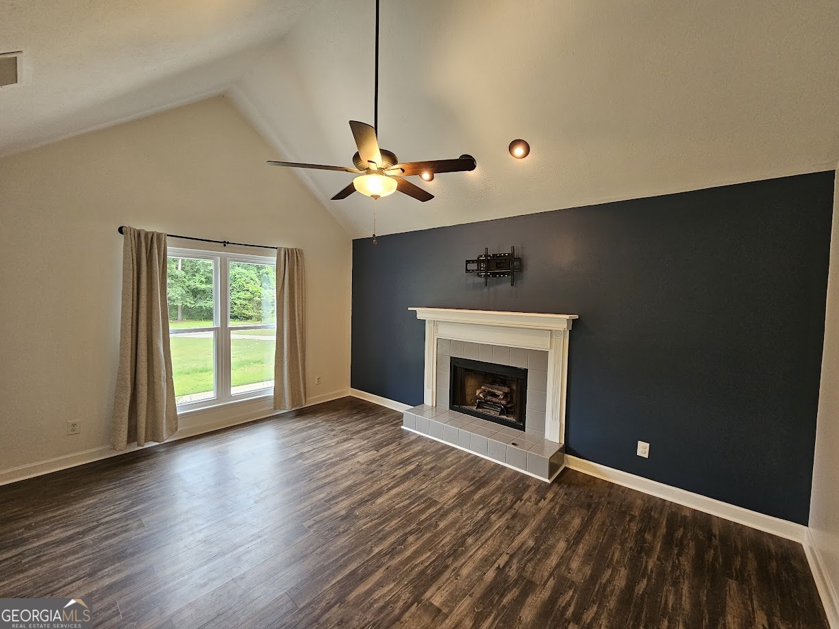 65 Tralee Trace Sharpsburg, GA 30277 - Photo 4 of 21 a view of an empty room with a fireplace and a window
