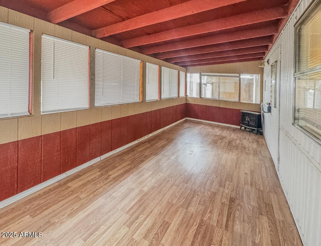 11100 West Alsdorf Road, Unit 10 Arizona City, AZ 85123 - Photo 16 of 19 a view of an empty room with wooden floor and staircase