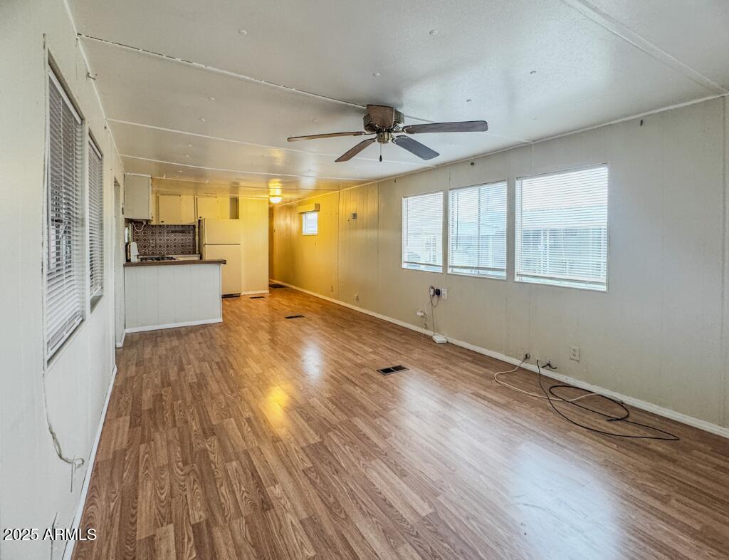 11100 West Alsdorf Road, Unit 10 Arizona City, AZ 85123 - Photo 2 of 19 an empty room with wooden floor and windows