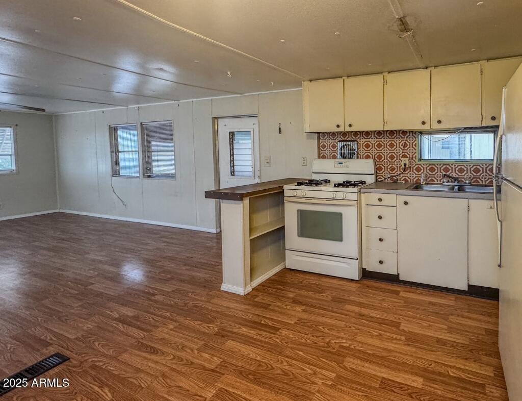 11100 West Alsdorf Road, Unit 10 Arizona City, AZ 85123 - Photo 3 of 19 a kitchen with granite countertop a stove and a sink