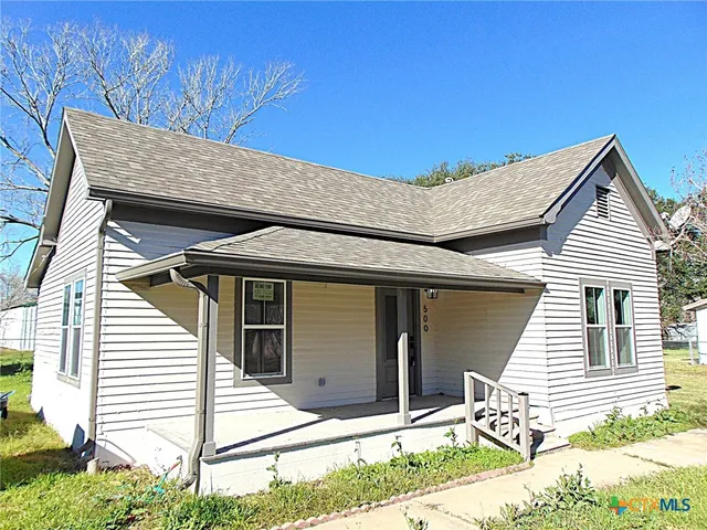 a view of house with backyard