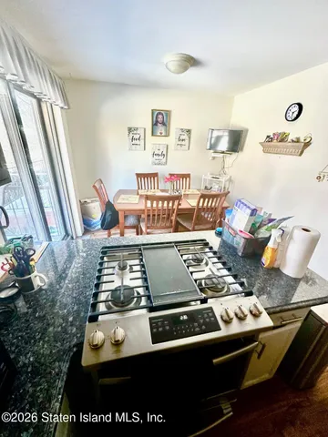 a bedroom with a bed and teddy bear on the dresser