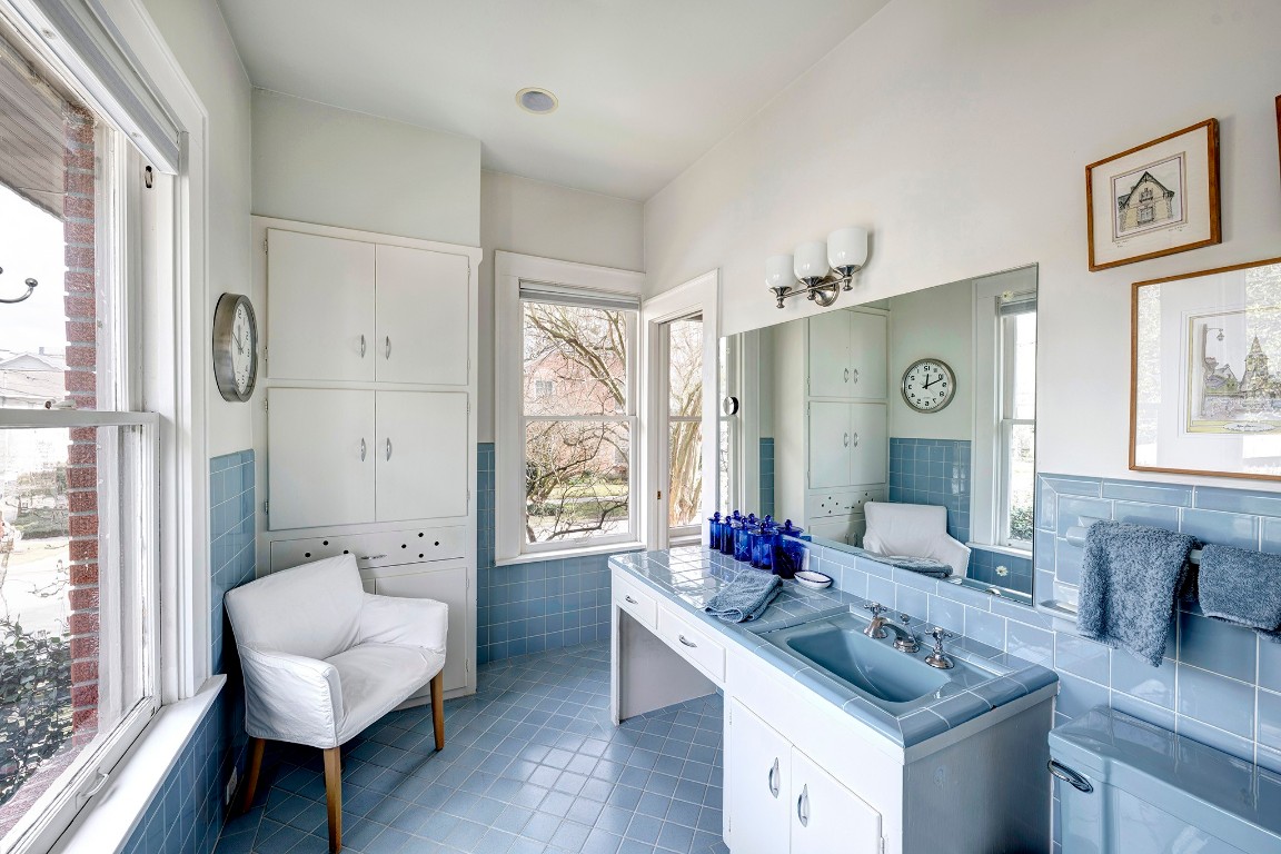 1902 Bolsover Street Houston, TX 77005 - Photo 15 of 27 En-suite primary bath features vintage tile, built-in storage, and vanity knee space.