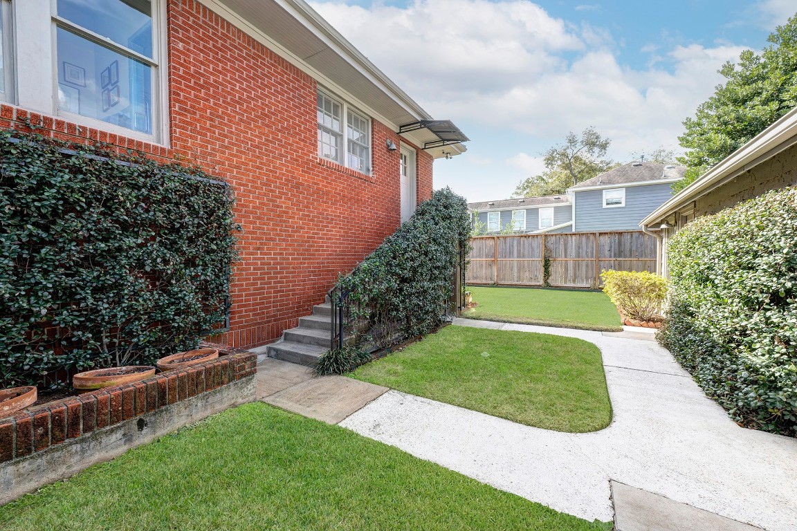 1902 Bolsover Street Houston, TX 77005 - Photo 22 of 27 Walkway from the detached garage leads to the back door, offering easy access to the kitchen.