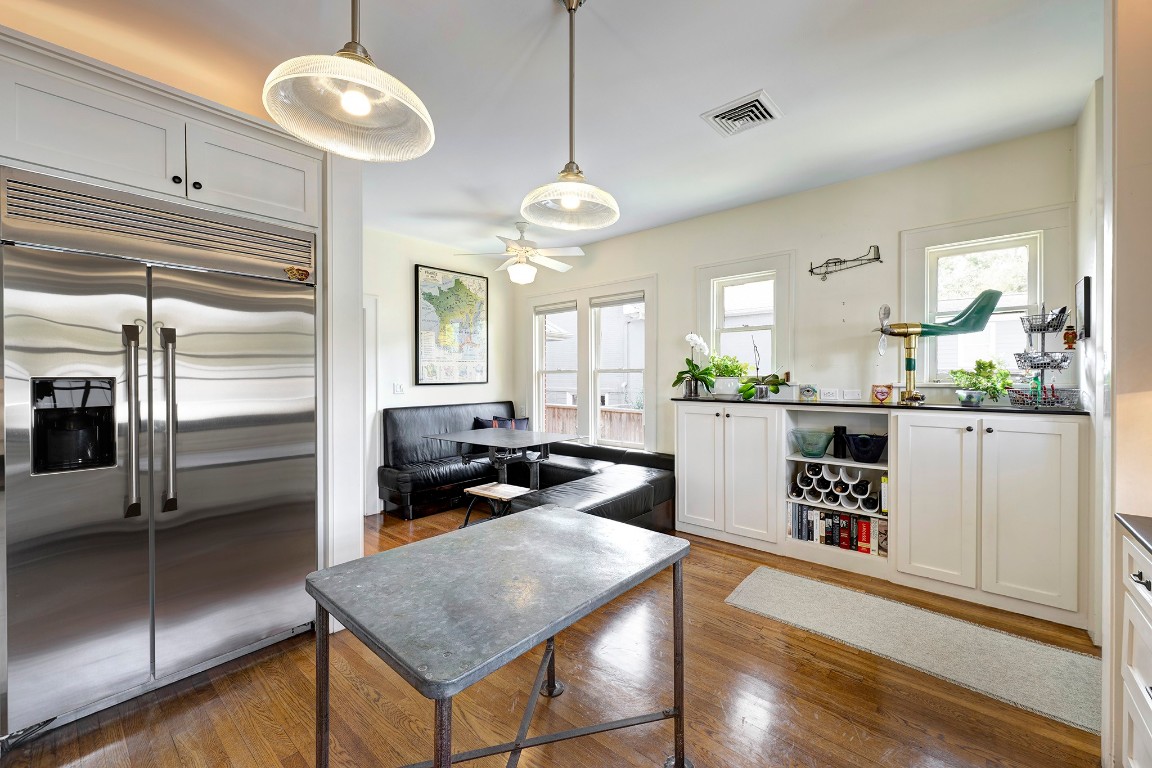 1902 Bolsover Street Houston, TX 77005 - Photo 10 of 27 Wood floors continue into the kitchen and breakfast room, and built-in storage provides versatile space for both display and organization.