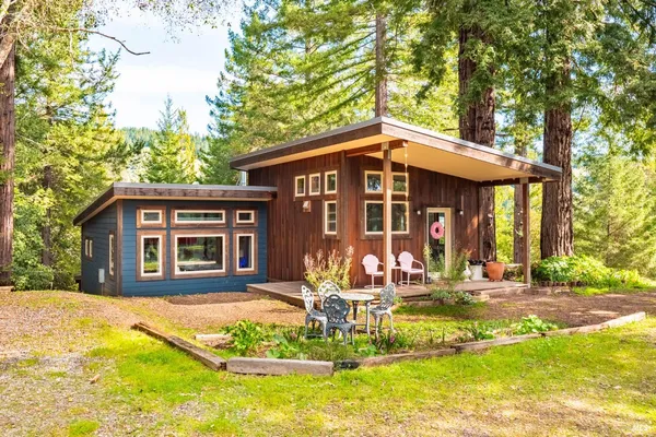 a front view of a house with swimming pool and furniture