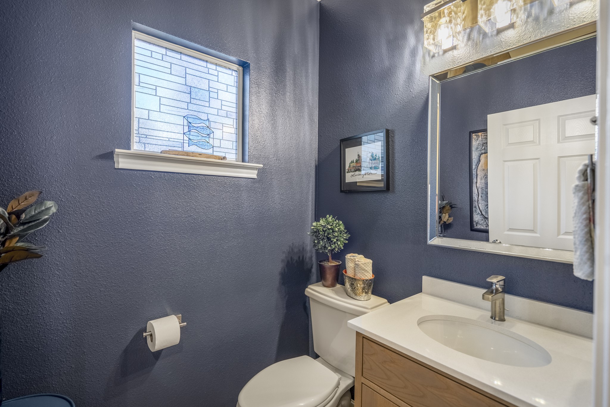 615 Inlet Drive Livingston, TX 77351 - Photo 28 of 50 a bathroom with a sink mirror and toilet