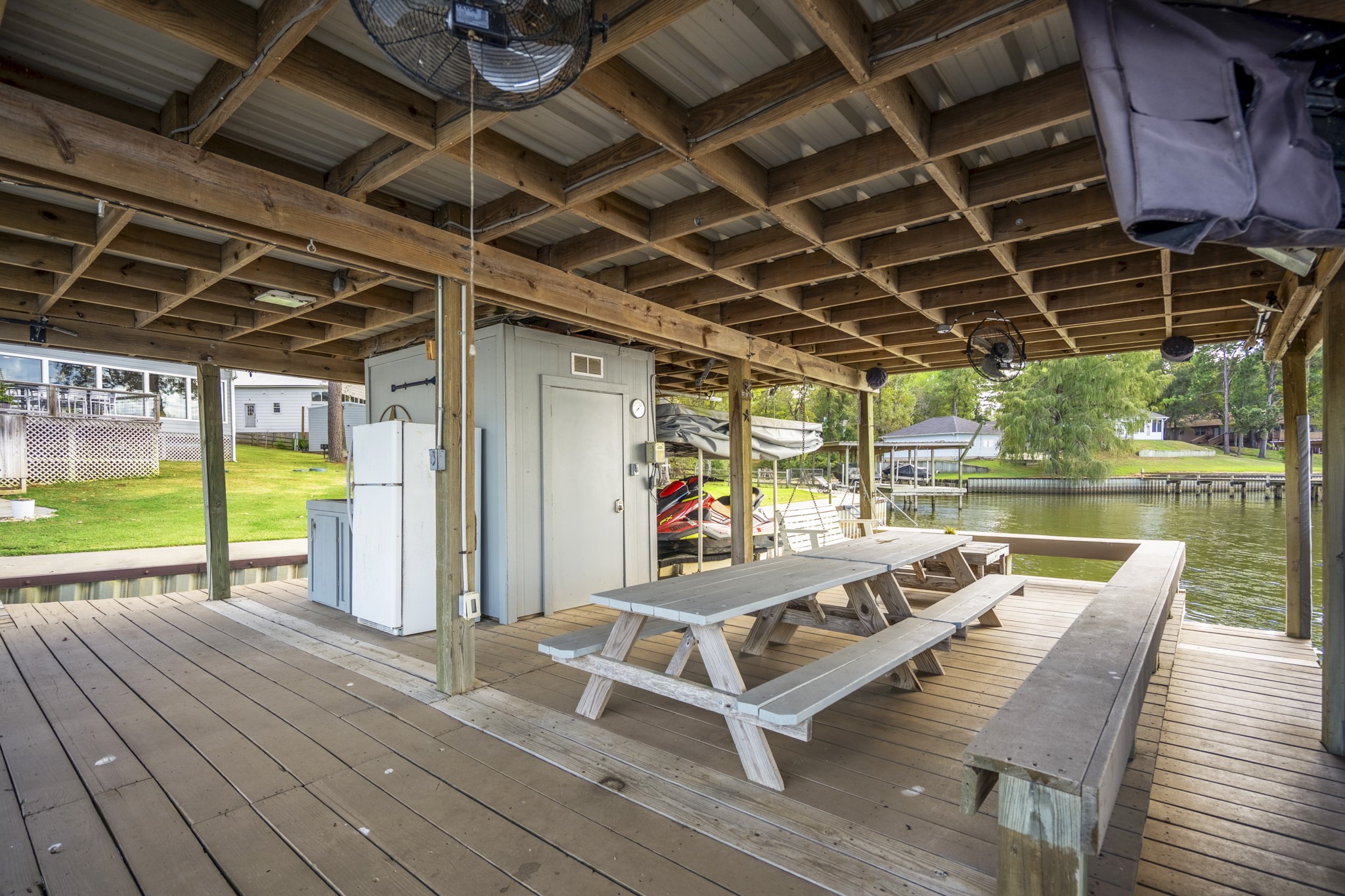 615 Inlet Drive Livingston, TX 77351 - Photo 45 of 50 a view of a patio with table and chairs a barbeque with floor to ceiling window with wooden floor