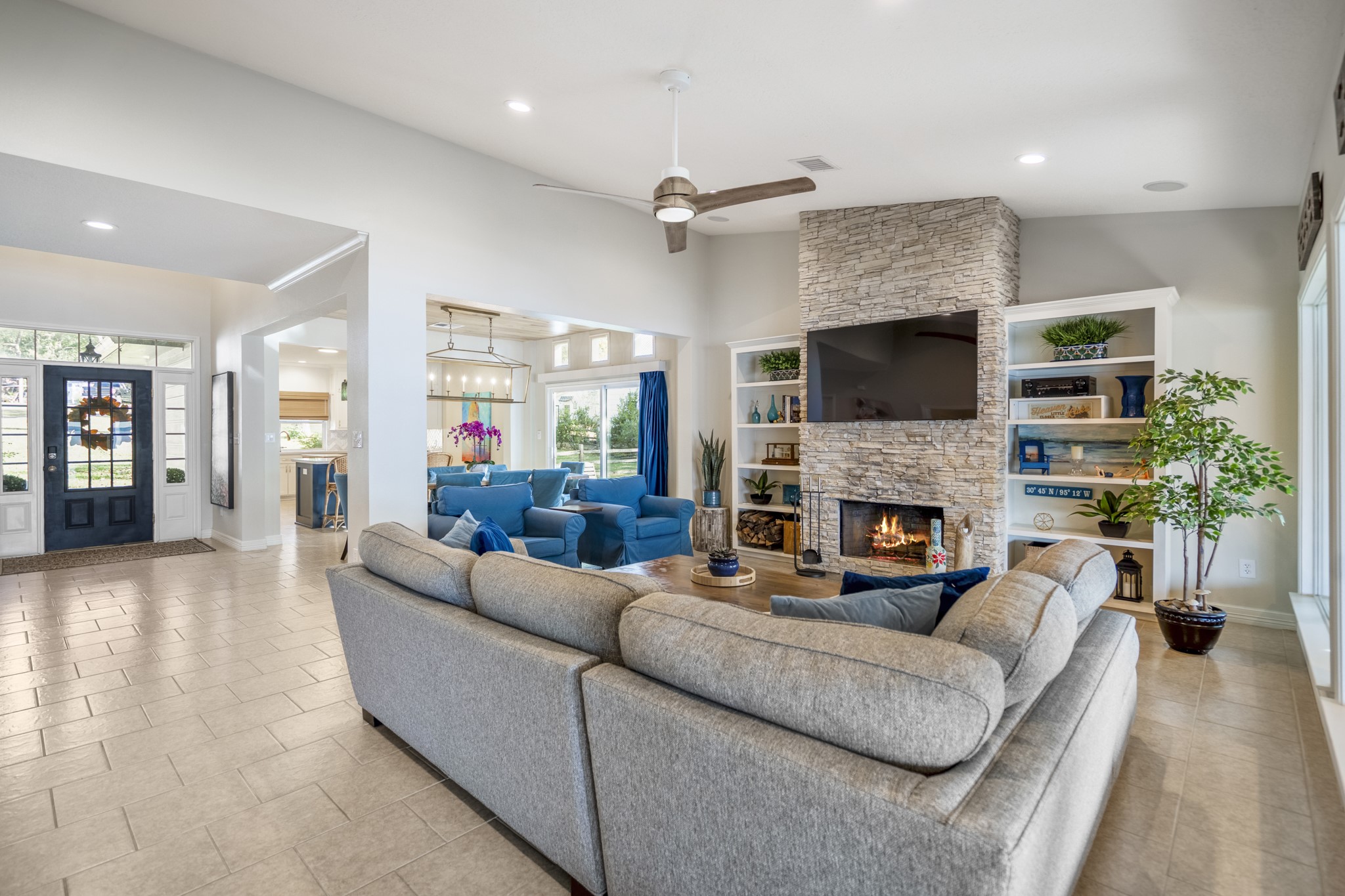 615 Inlet Drive Livingston, TX 77351 - Photo 7 of 50 a living room with furniture a fireplace a flat screen tv and potted plant