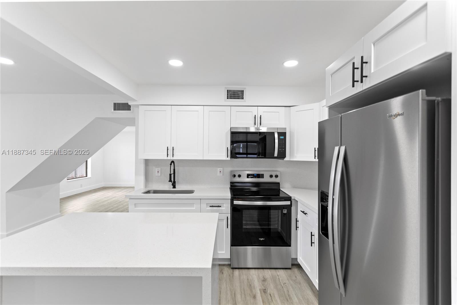 11301 Southwest 177th Street Miami, FL 33157 - Photo 12 of 31 a kitchen with stainless steel appliances a refrigerator sink and stove