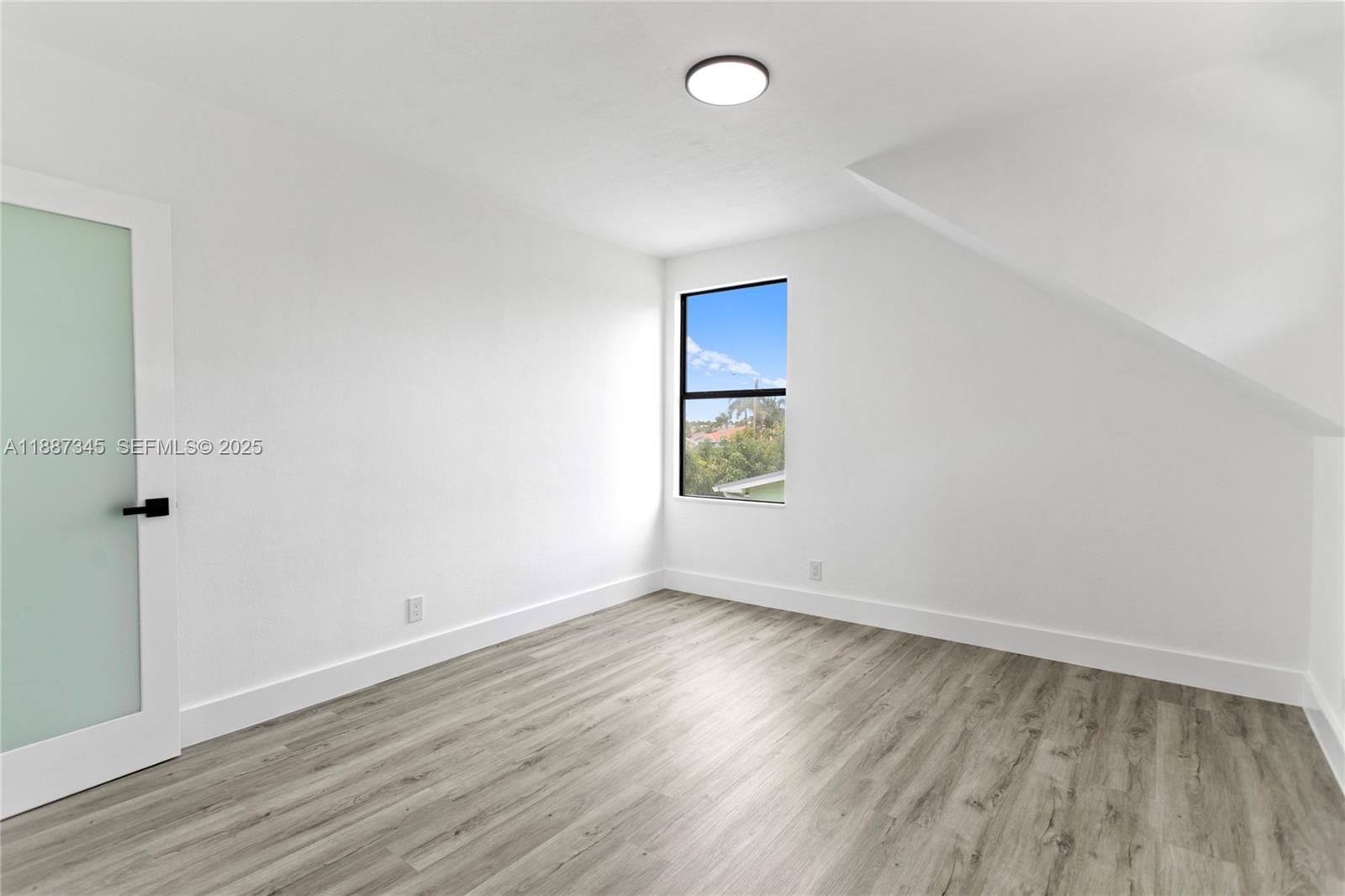 11301 Southwest 177th Street Miami, FL 33157 - Photo 14 of 31 an empty room with wooden floor and windows