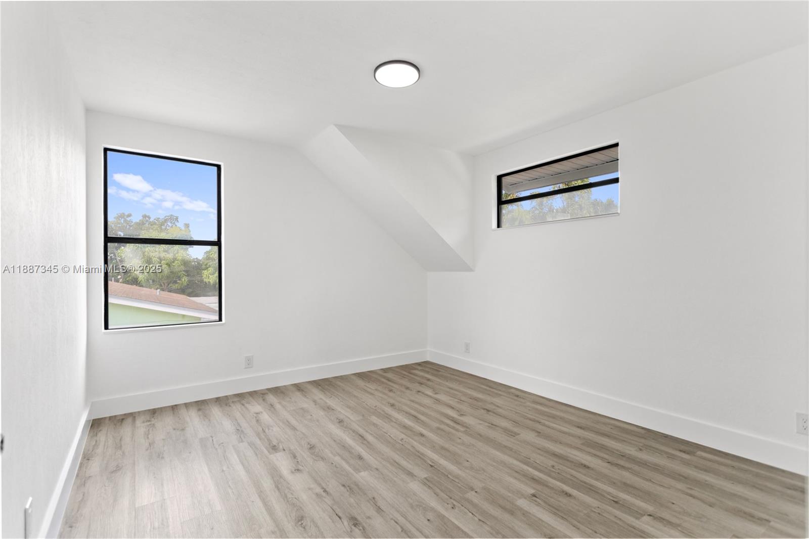 11301 Southwest 177th Street Miami, FL 33157 - Photo 15 of 31 an empty room with wooden floor and windows
