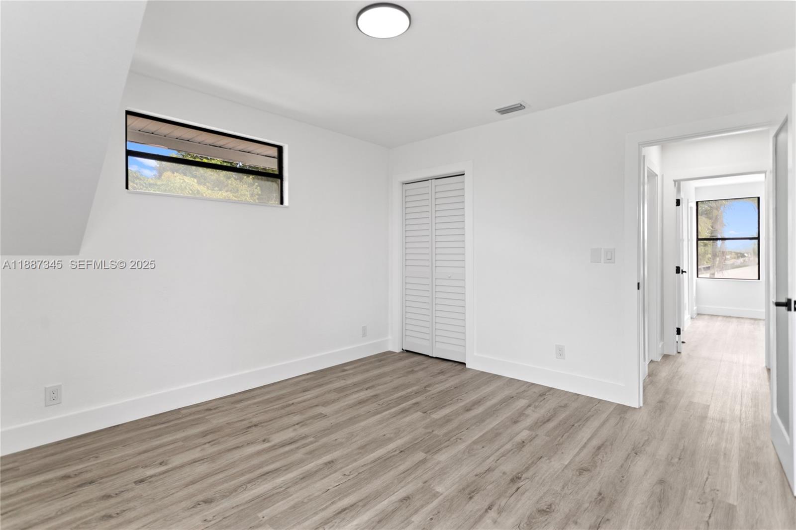 11301 Southwest 177th Street Miami, FL 33157 - Photo 16 of 31 an empty room with wooden floor and windows