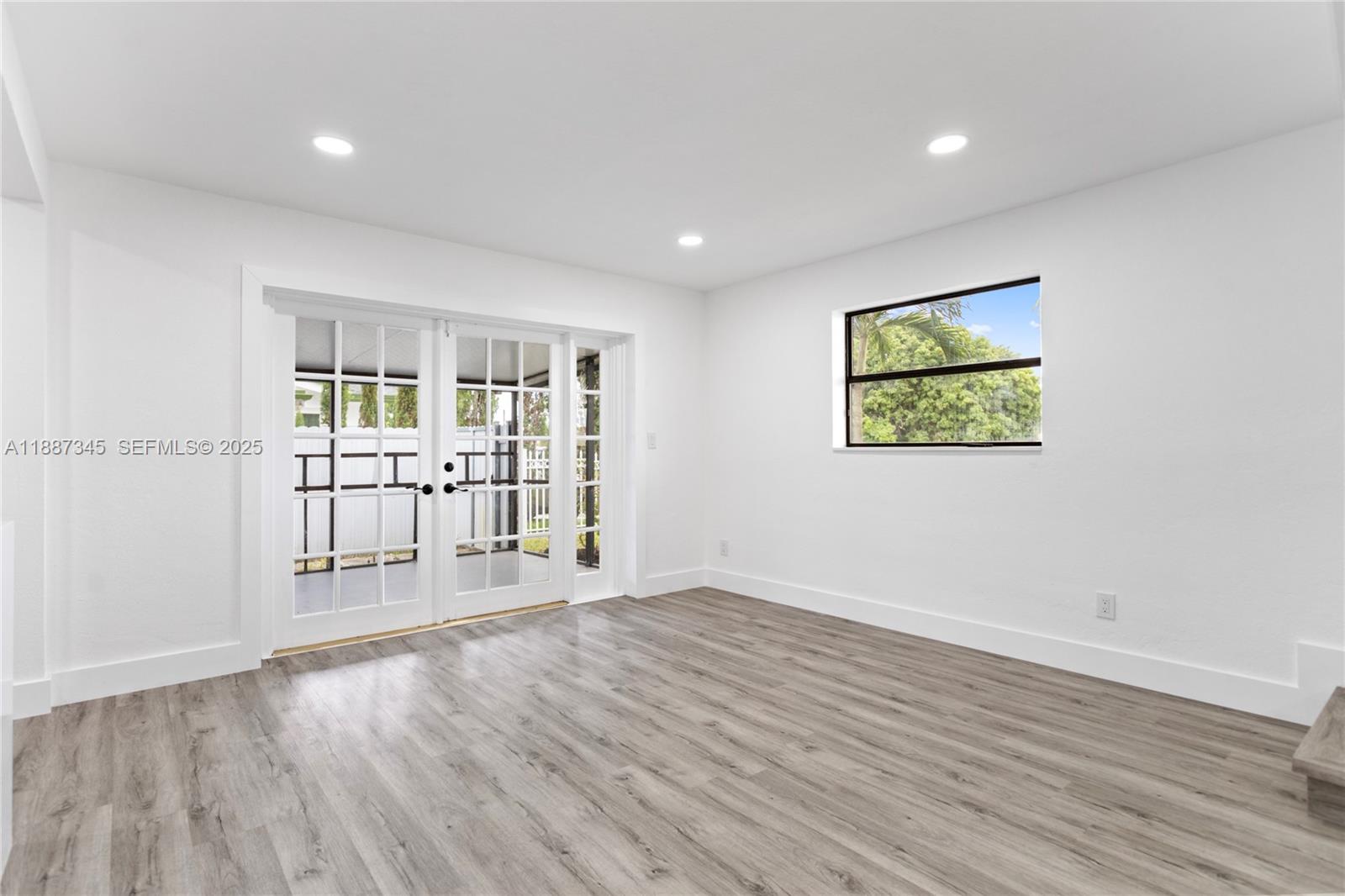 11301 Southwest 177th Street Miami, FL 33157 - Photo 17 of 31 a view of an empty room with wooden floor and a window