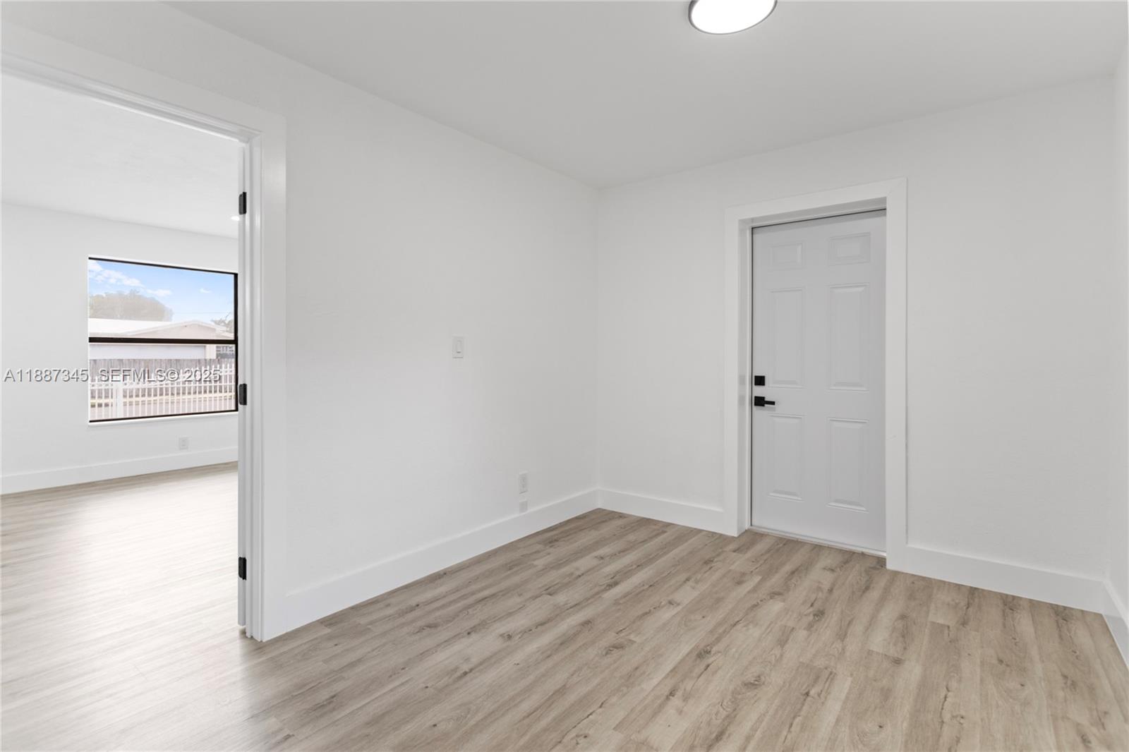 11301 Southwest 177th Street Miami, FL 33157 - Photo 20 of 31 an empty room with wooden floor and windows