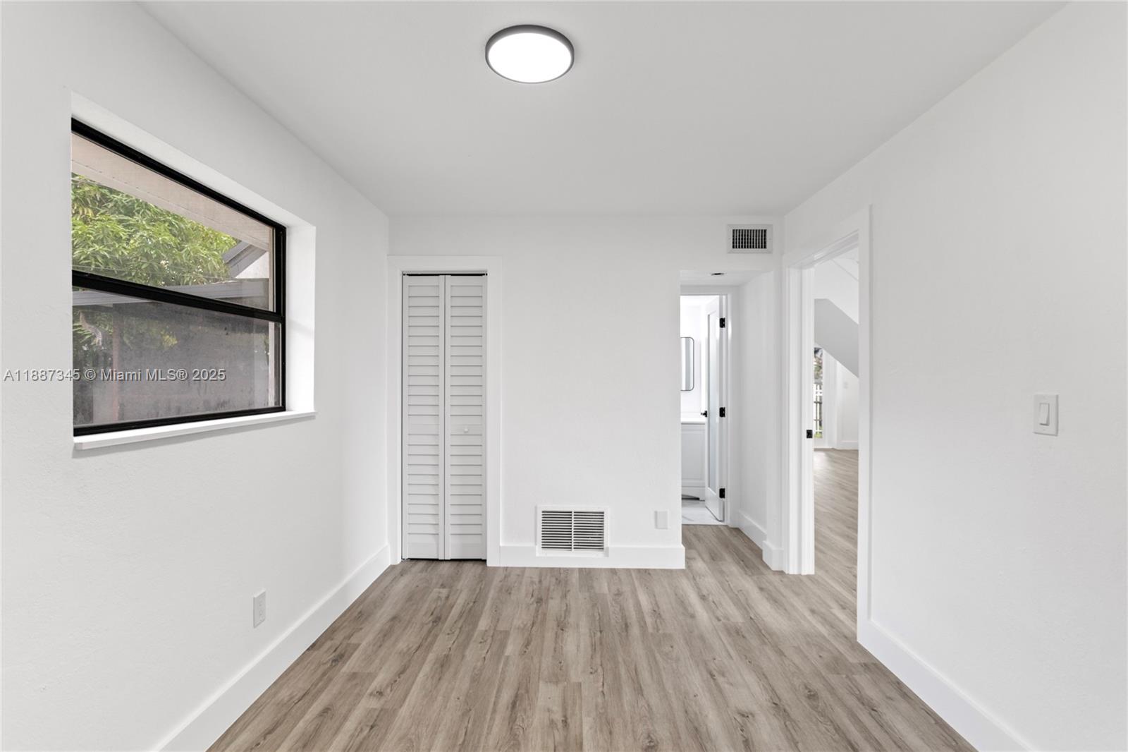 11301 Southwest 177th Street Miami, FL 33157 - Photo 22 of 31 a view of an empty room with wooden floor and a window