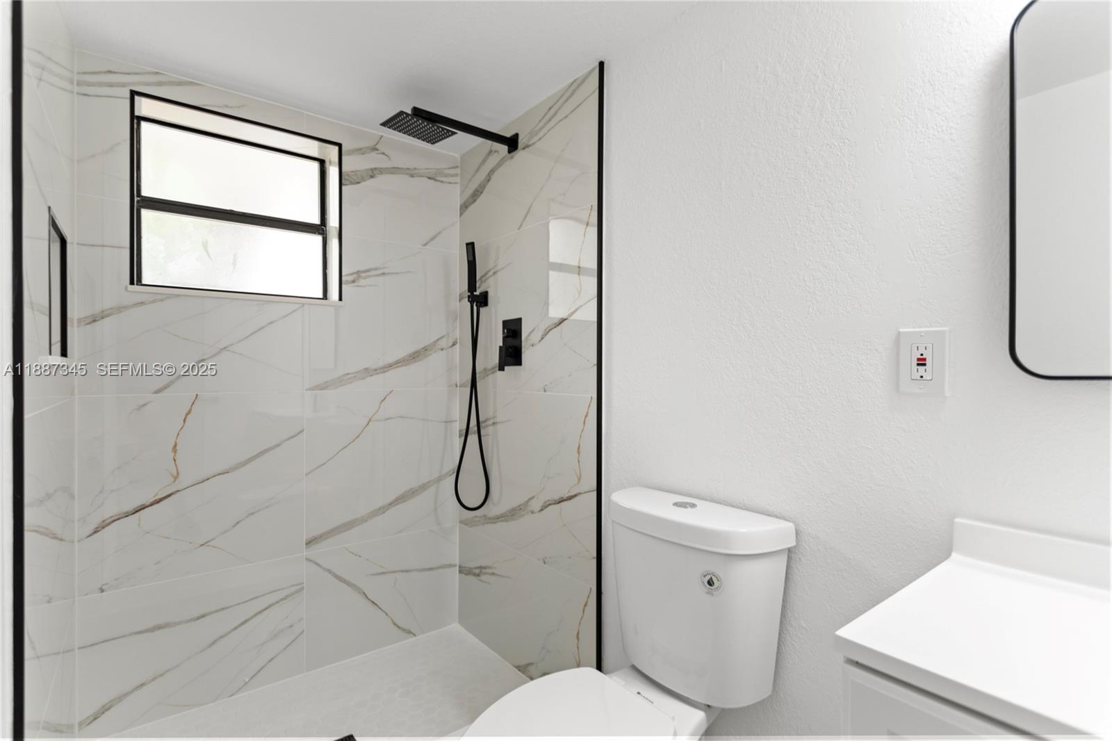 11301 Southwest 177th Street Miami, FL 33157 - Photo 23 of 31 a white toilet sitting next to a bathroom sink